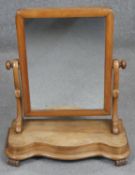 A Victorian walnut swing frame toilet mirror. H.57cm