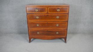 A Georgian mahogany and satinwood chest of drawers on swept bracket supports. H.93 W.103 D.47cm