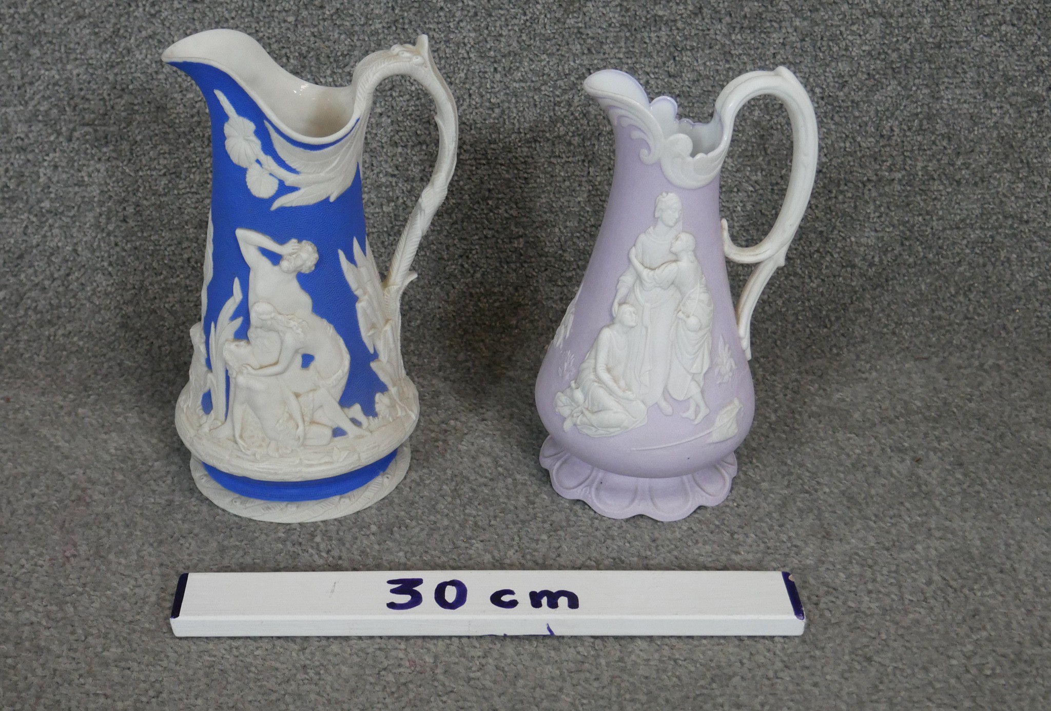 Two 19th century Jasperware ceramic Samuel Alcock jugs. One lavender parian with Naomi & her - Image 2 of 3