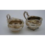 Two Vctorian silver milk jugs. One with an engraved scrolling foliate design and beaded rim and