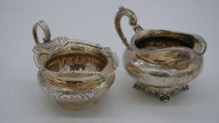 Two Vctorian silver milk jugs. One with an engraved scrolling foliate design and beaded rim and