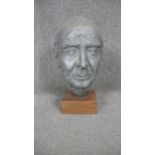 A sculpted metal head of an elderly gentleman mounted on a wooden stand. H.37cm