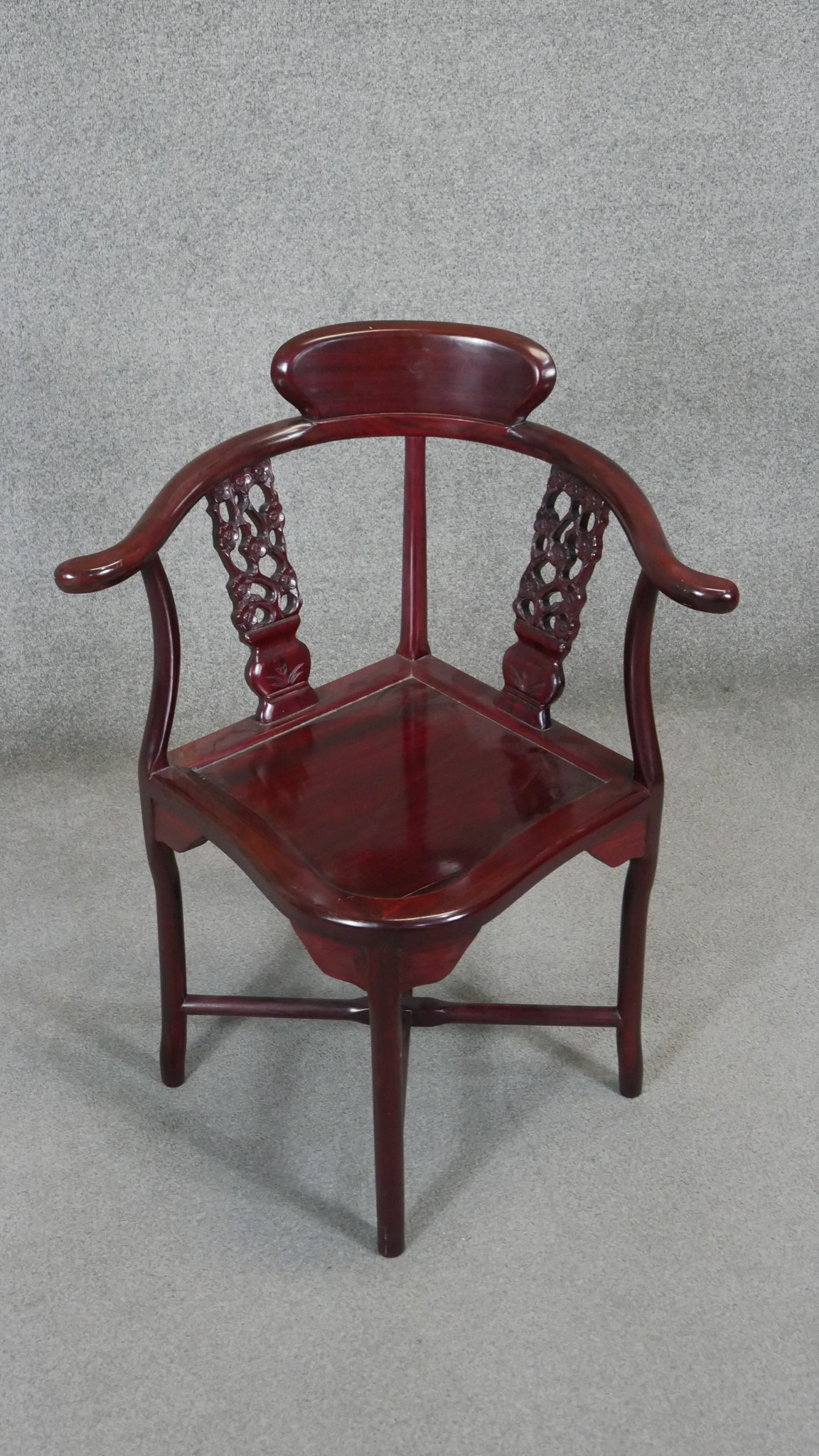 A Chinese hardwood corner armchair.