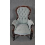 A mid 19th century carved mahogany framed armchair, newly reupholstered on bulbous reeded