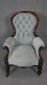 A mid 19th century carved mahogany framed armchair, newly reupholstered on bulbous reeded