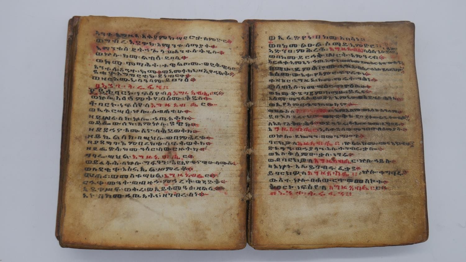 A 19th century Ethiopian coptic manuscript on vellum in wooden boards. Handwritten script in red and - Image 3 of 8