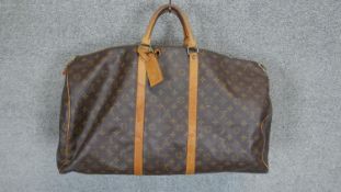 A Louis Vuitton "Keepall" 60, date code: MI1911, Monogram canvas exterior with leather trim, dual