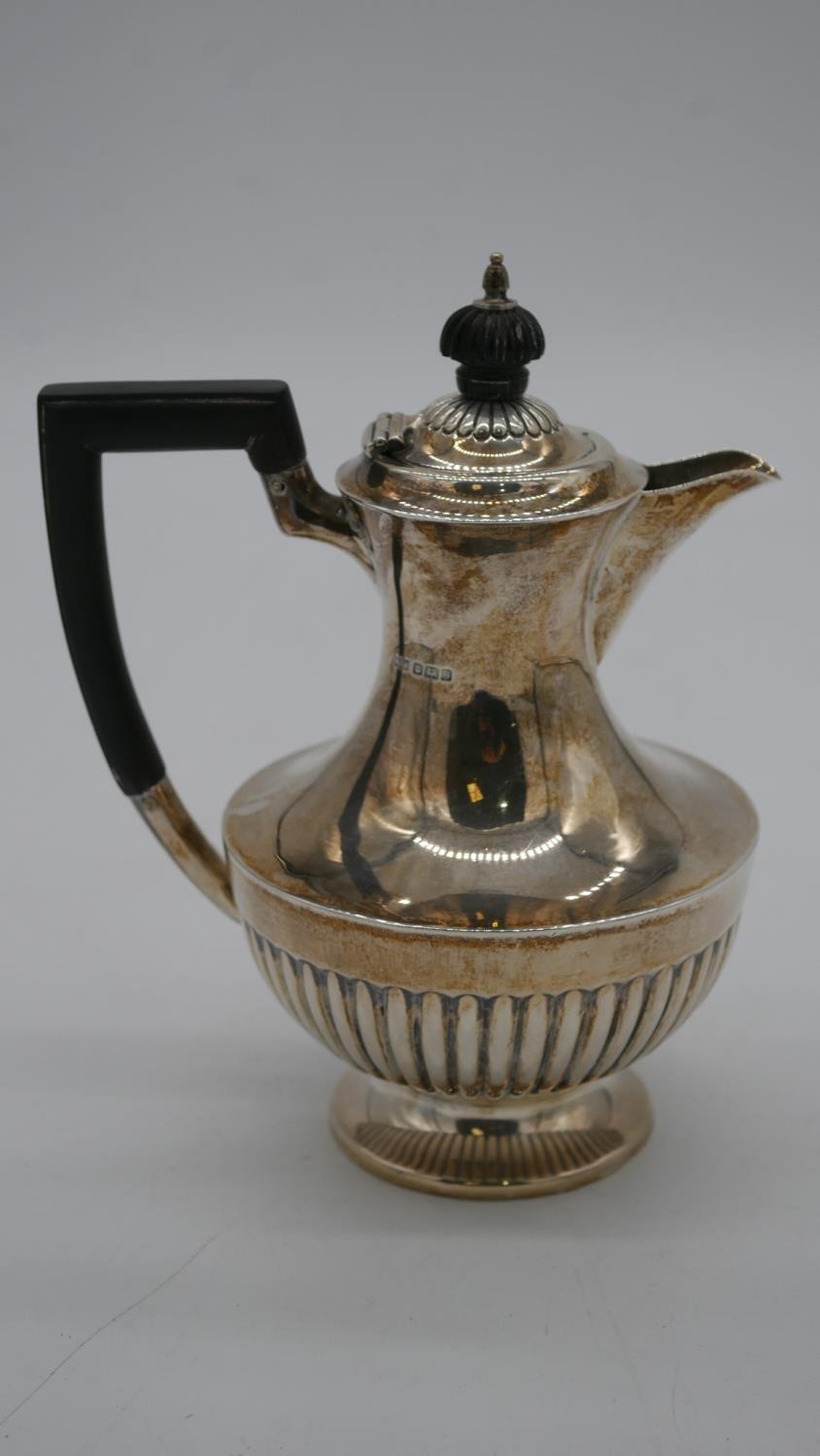 An Edwardian Mappin and Webb sterling silver gadrooned coffee pot with ebony handle. Hallmarked M&W,