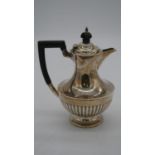An Edwardian Mappin and Webb sterling silver gadrooned coffee pot with ebony handle. Hallmarked M&W,