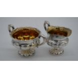 A Finnish silver gadrooned design twin handled sugar bowl and milk jug, with gilded interior.