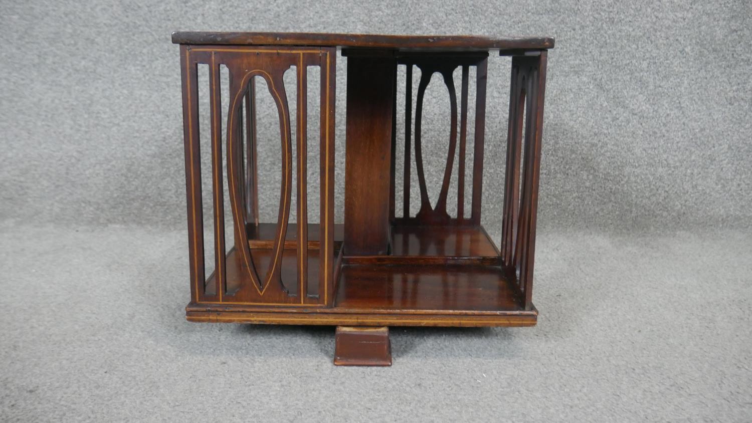 An Edwardian mahogany and satinwood inlaid revolving table top bookcase. H30 W36cm