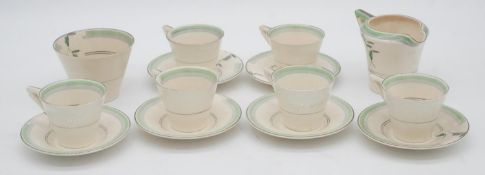 A six person Soho pottery Solian ware green floral pattern coffee set. Maker's mark to the base.