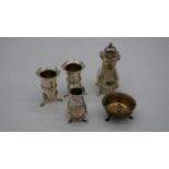 A collection of silver salts and a pepper shaker. Various British hallmarks. Three with lion paw