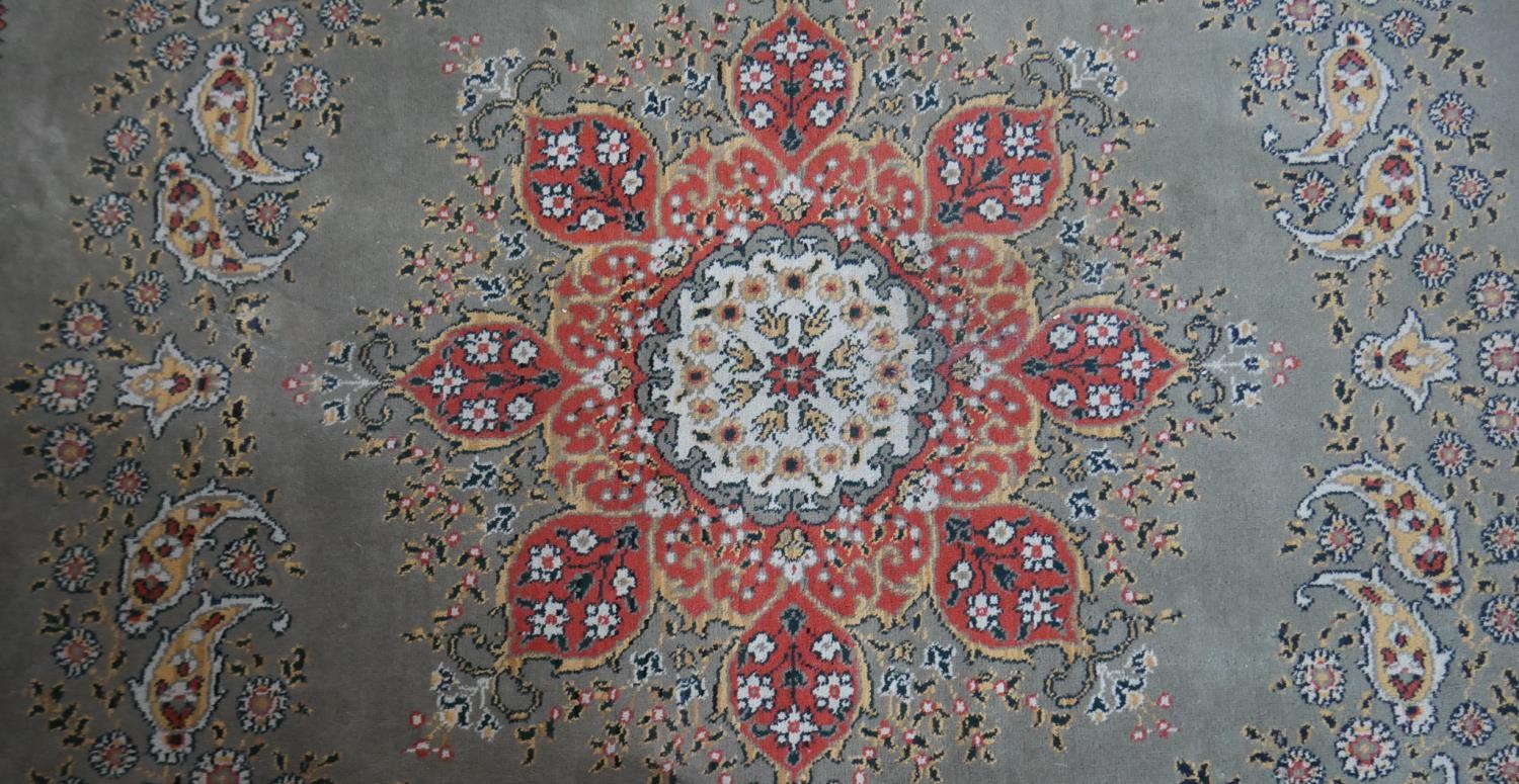 A Persian style woollen carpet with floral central medallion within foliate multiple borders. - Image 4 of 4