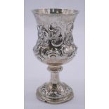 An early Victorian silver repousse stemmed goblet with a scrolling floral and foliate design.