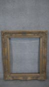 A 19th century carved giltwood frame with relief shell motifs to the corners and floral sprigs.