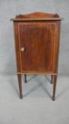 An Edwardian mahogany and satinwood inlaid pot cupboard on tapering square supports terminating in