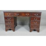 A Georgian style mahogany three part pedestal desk with inset tooled leather top. H180 W.136 D.67cm