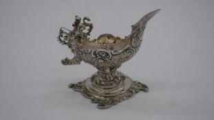 A Continental silver milk jug in the form of a fairy boat with seated fairy figure on the back on
