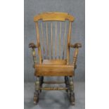 A 19th century beech and pine stick back rocking chair.
