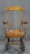 A 19th century beech and pine stick back rocking chair.