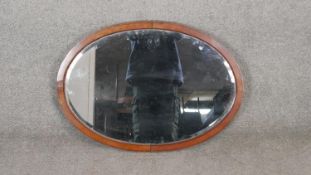 A C.1900 mahogany and ebony strung wall mirror. H.53 W.72cm