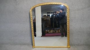 A 19th century gilt framed overmantel mirror in spiral beaded arched frame. H133 W118