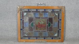 An oak framed Victorian stained glass panel with central plaque decorated with ducks and waterlillys