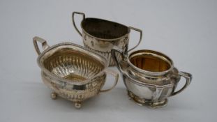 Three two handled silver sugar bowls. Two with gadrooned design, hallmarked: Birmingham, 1894 and GA