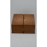 A 19th century oak stationery box with fitted interior. H.30 W.39cm