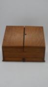 A 19th century oak stationery box with fitted interior. H.30 W.39cm