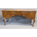 A mid Georgian style figured walnut sideboard raised on carved cabriole supports. H.92 W.183 D.58cm