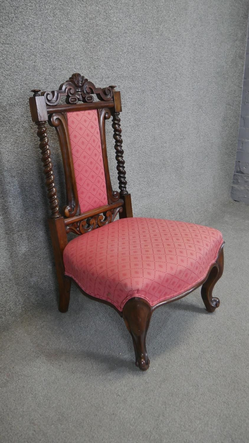 A mid 19th century rosewood nursing chair with carved top rail and barleytwist supports on carved - Image 2 of 3