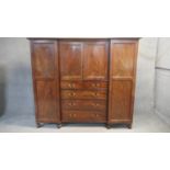 A mid 19th century figured mahogany three section compactum wardrobe fitted with drawers, cupboard
