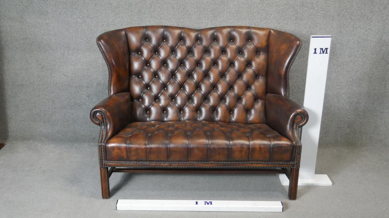A Georgian style wingback two seater armchair in deep buttoned and studded leather upholstery on - Image 3 of 5