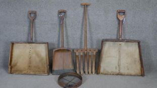 A collection of five antique wooden agricultural tools including grain shovels and hay forks. H.