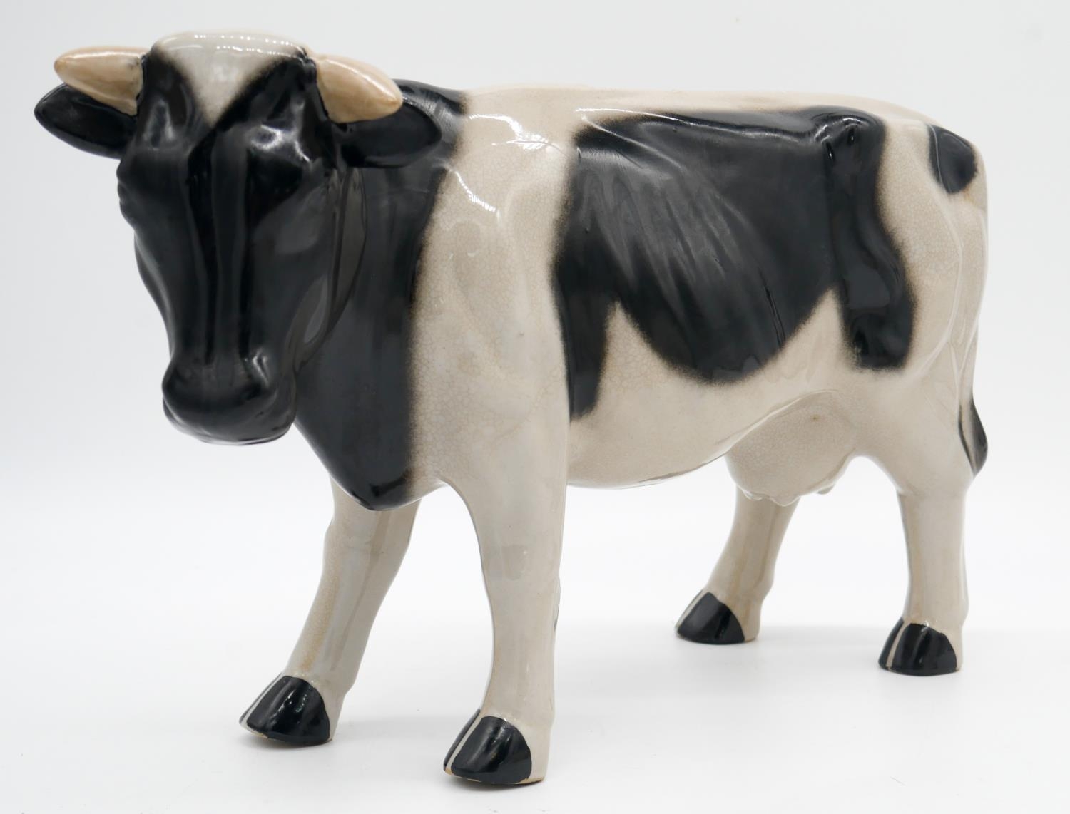 A glazed ceramic cow along with a resin sculpture of a polar bear. H.23cm - Image 3 of 8