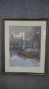 A framed and glazed watercolour Dutch barges in a port town, indistinctly signed and dated. H.60 W.