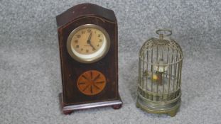 A vintage Japanese brass birdcage clock with plastic bird and a walnut veneered mantle clock with