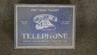 A boxed Chad Valley Co. Ltd. Improved Telephone, contains two bakelite phones with walnut finish and