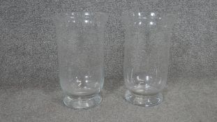 A pair of large clear blown glass candle holders. H.30