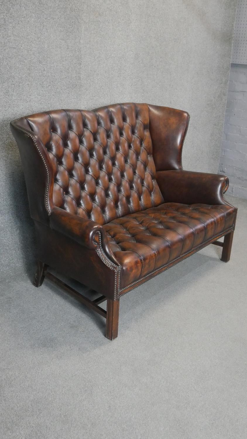 A Georgian style wingback two seater armchair in deep buttoned and studded leather upholstery on - Image 2 of 5