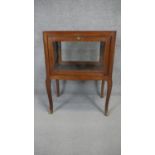 A Louis XV style quarter veneered vitrine with central fan patera inlay and glazed fall front and