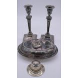 A pair of silver plate column and swag design candlesticks along with an oval lidded serving dish