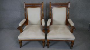 A pair of late 19th century newly upholstered carved oak armchairs on reeded bulbous supports. h110