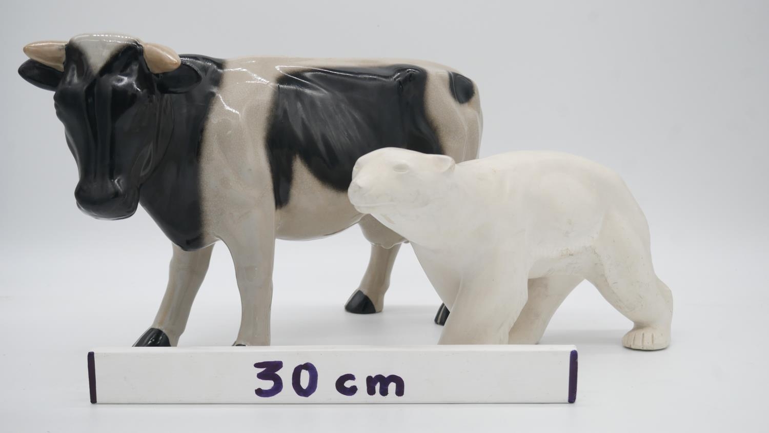 A glazed ceramic cow along with a resin sculpture of a polar bear. H.23cm - Image 8 of 8