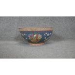 A 20th century Chinese porcelain hand painted bowl decorated with temple scenes, abstract patterns