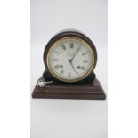 A mahogany vintage mantle clock by Comitti of London, white enamel dial with black Roman numerals.