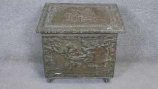 A vintage brass embossed log box with figural decoration. H.47 W.50 D.33cm