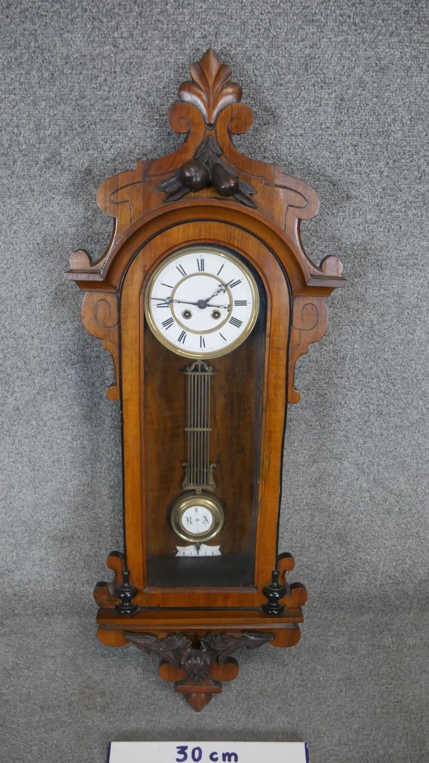 A 19th century Vienna regulator wall clock with eight day movement and white enamel dial in a carved - Image 2 of 6